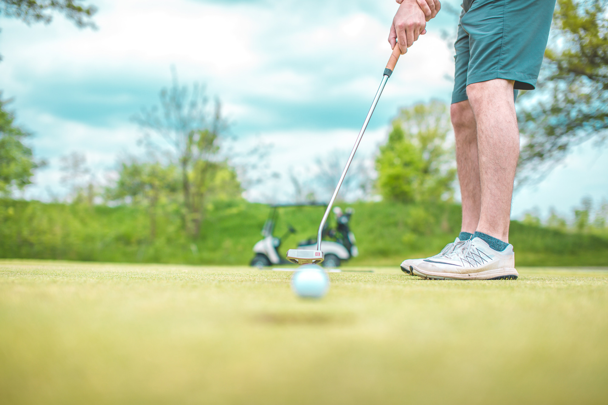 man putts on a green